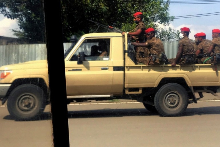 Ethiopian military ride on their pick-up truck as they patrol the streets following protests in Addis Ababa