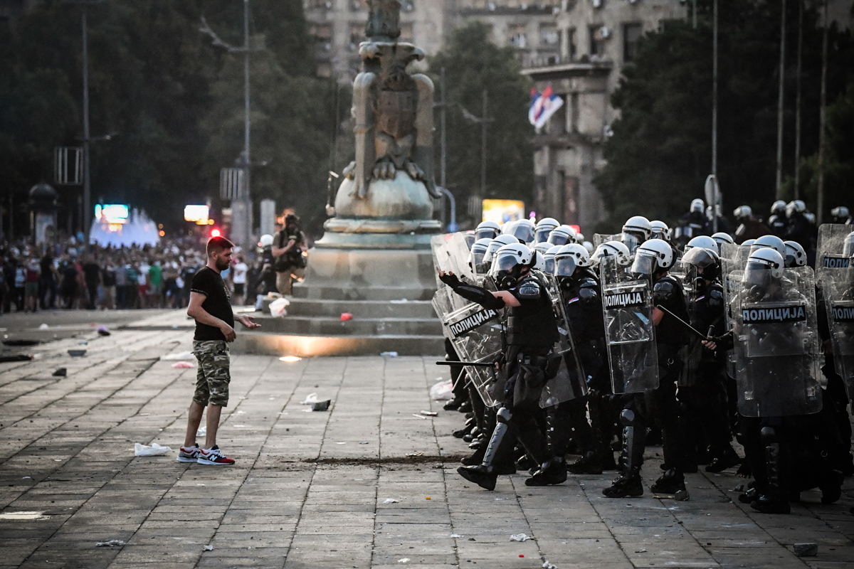 Protesters clash with police in front of Serbia's National Assembly building in Belgrade on July 8, 2020 during a demonstration against a weekend curfew announced to combat a resurgence of COVID-19 in