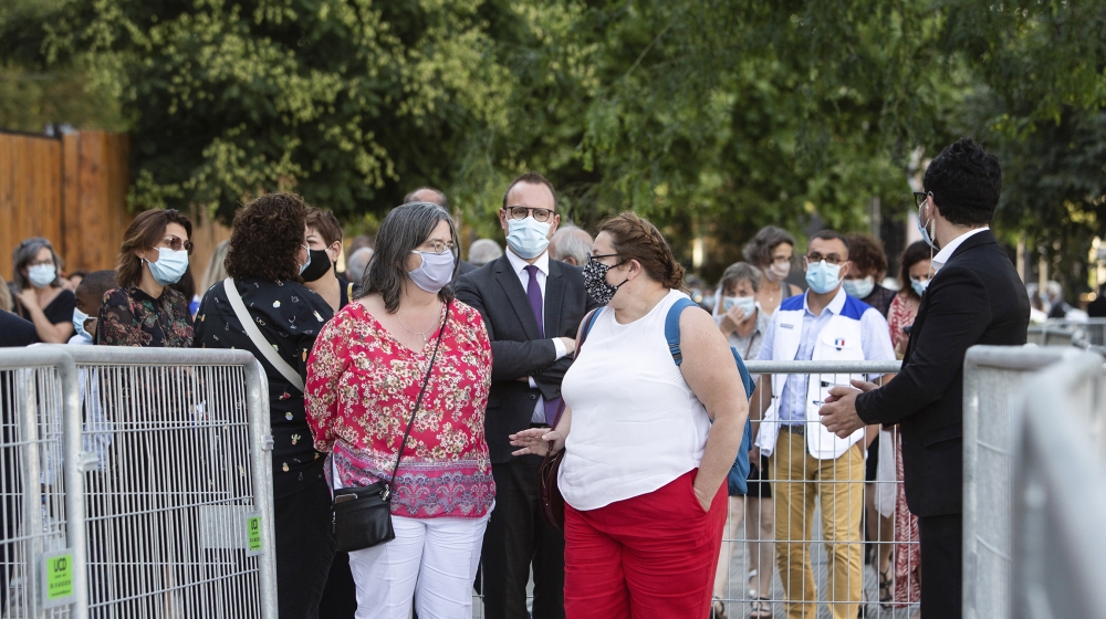 People, wearing protective face mask, queue outside the Grand Palais prior to a reception called by French Health Minister and gathering 800 medical staff that helped during the novel coronavirus (COV
