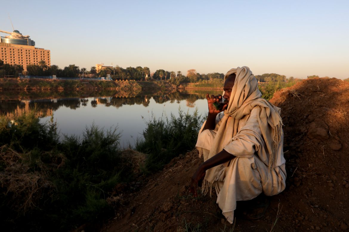Mohamed Ahmed al Ameen, 55, a brick maker, drinks a cup of tea as he sits on the edge of the Blue Nile near an open-air factory on Tuti Island, Khartoum, Sudan, February 14, 2020. "I consider the Nile