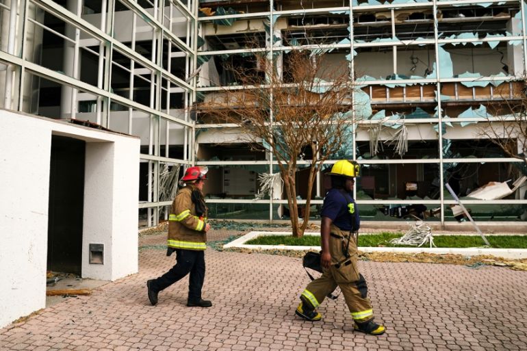 Firefighters walk in front of a damaged building after Hurricane Laura passed through Lake Charles, Louisiana, U.S. August 27, 2020. REUTERS/Elijah Nouvelage