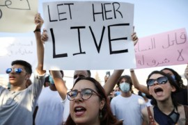 Demonstrators shout slogans during a protest against the incidents of violence against women and to demand more stringent consequences for perpetrators, in front of the Parliament in Amman