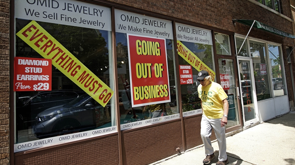 A man walks past a retail store that is going out of business due to the coronavirus pandemic in Winnetka, Ill., Tuesday, June 23, 2020. More than 1.4 million laid-off Americans applied for unemployme