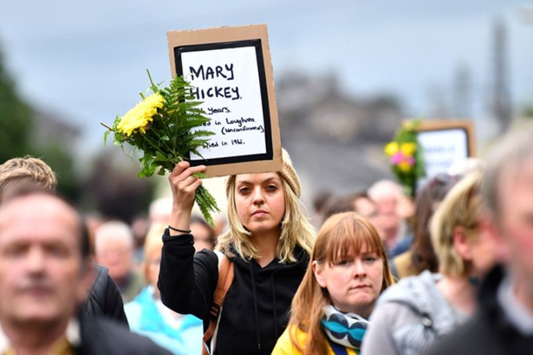 A woman attends a vigil at the site of the Tuam babies graveyard
