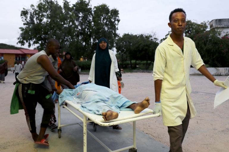 Paramedics and civilians carry an injured person on a stretcher at Madina hospital after a blast at the Elite Hotel in Lido beach in Mogadishu, Somalia August 16, 2020. REUTERS/Feisal Omar