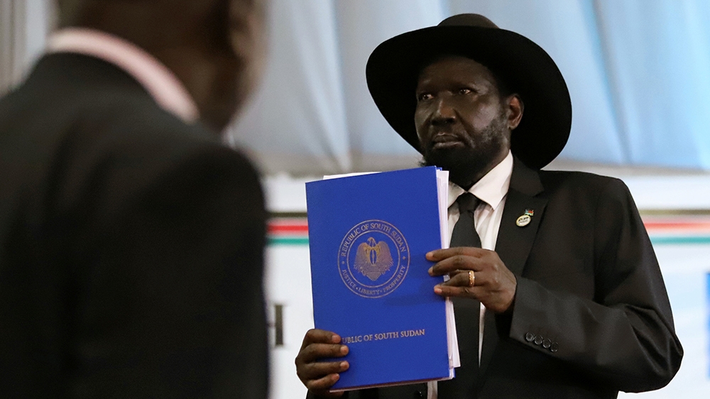 South Sudan's President Salva Kiir Mayardit holds a copy of a signed peace agreement between Sudan and five key rebel groups, a significant step towards resolving deep-rooted conflicts that raged unde
