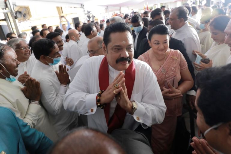 Sri Lanka''s Prime Minister Mahinda Rajapaksa gestures as he leaves after his swearing in ceremony as the new Prime Minister, at Kelaniya Buddhist temple in Colombo
