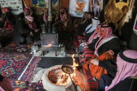 Syrian Bedouins roast coffee beans in a camp during a gathering of tribesmen near the town of Hamouria, in the eastern Ghouta region on the outskirts