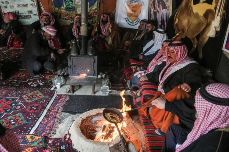 Syrian Bedouins roast coffee beans in a camp during a gathering of tribesmen near the town of Hamouria, in the eastern Ghouta region on the outskirts