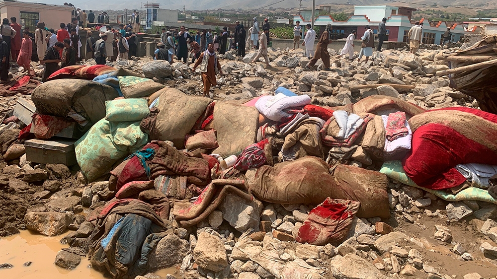 Afghans rescue people after heavy flooding in Parwan province of kabul, Afghanistan, Wednesday, Aug. 26, 2020.Heavy flooding in northern Afghanistan has killed more than two dozen people and injured s
