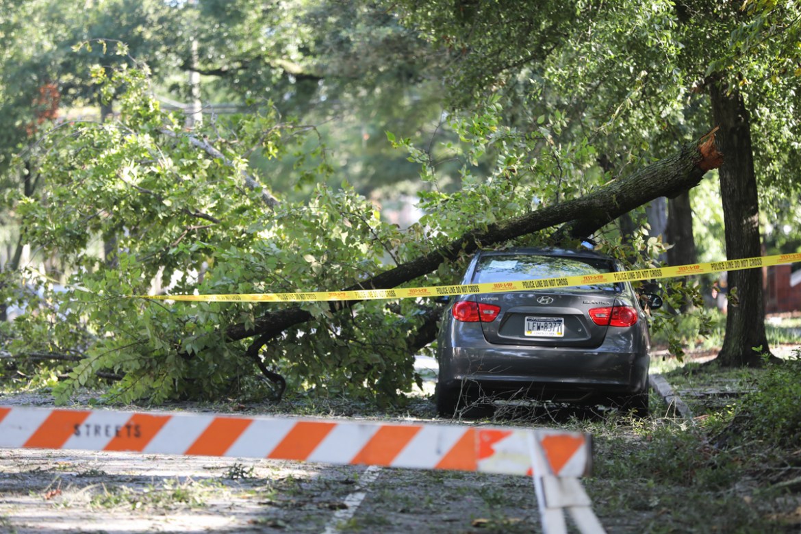A tree branch rests on a car after Hurricane Isaias made landfall near the town the night before in Wilmington, North Carolina on August 4, 2020. - Hurricane Isaias slammed into North Carolina bringin