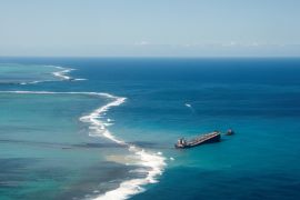 A general view shows the bulk carrier ship MV Wakashio, that ran aground on a reef, at Riviere des Creoles