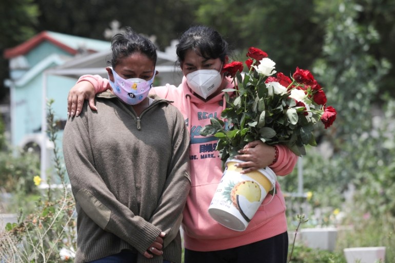 Relatives react near the coffin of a man, during his funeral at the local cemetery, as the coronavirus disease (COVID-19) outbreak continues in Mexico City, Mexico, August 6, 2020. REUTERS/Henry Romer