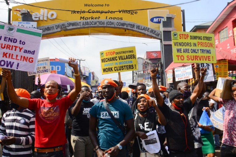 Demonstrators and supporters of the convener of &quot;#Revolution Now&quot;, Omoyele Sowore, hold placards in Lagos, Nigeria on August 5, 2020. - Omoyele Sowore, The protesters are protesting concerni