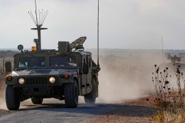 An Israeli military vehicle patrols near the Syria border in the Israeli-annexed Golan Heights on August 3, 2020, near the location where the army said it killed four men laying explosives at a securi