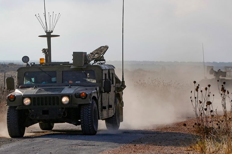 An Israeli military vehicle patrols near the Syria border in the Israeli-annexed Golan Heights on August 3, 2020, near the location where the army said it killed four men laying explosives at a securi