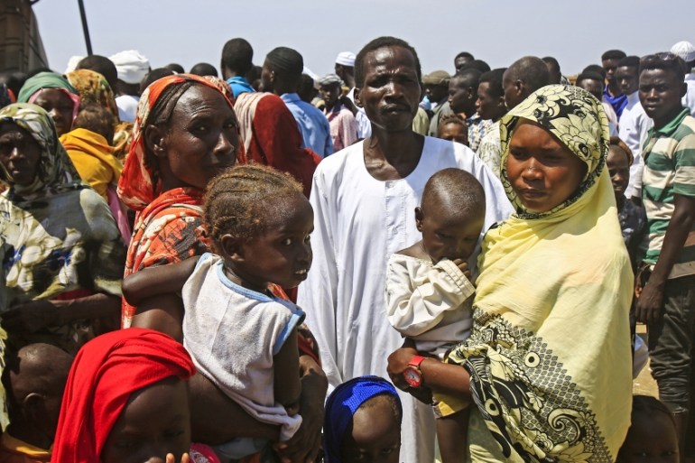 Displaced Sudanese queue to receive humanitarian aid supplies at the Kalma camp for internally displaced people in Darfur''s state capital Niyala on October 9, 2019. The camp hosts about 160,000 people