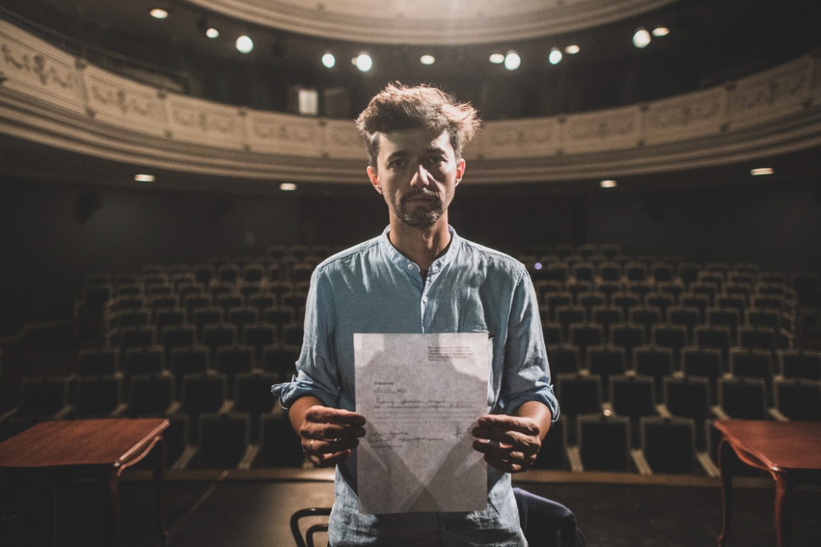 Mihail Zui, 39, an actor of the Yanka Kupala National Theater poses for a photo showing his resignation letter in Minsk, Belarus, Tuesday, Aug. 18, 2020. After the theater''s influential and popular di