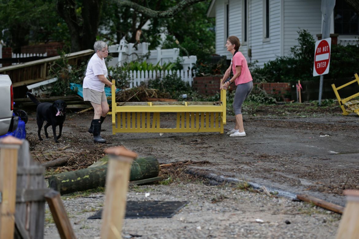 Residents begin to clean up following the effects of Hurricane Isaias in Southport, N.C., Tuesday, Aug. 4, 2020. (AP Photo/Gerry Broome)