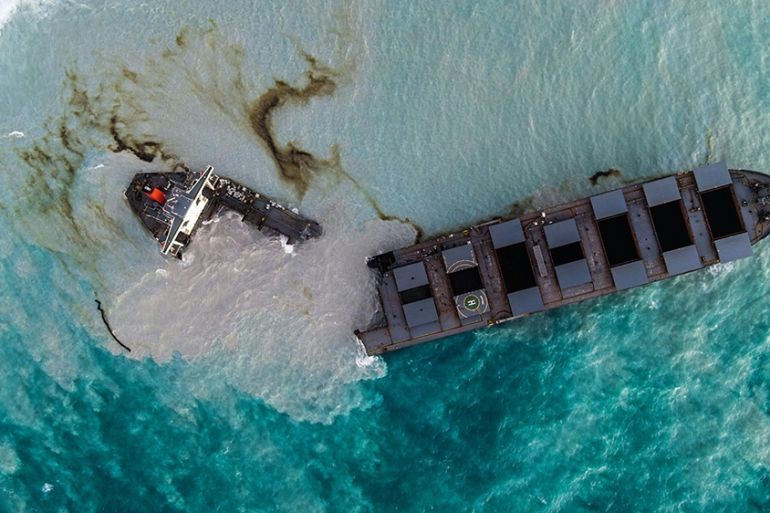 This aerial picture taken on August 16, 2020, shows the MV Wakashio bulk carrier that had run aground and broke into two parts near Blue Bay Marine Park, Mauritius. - A ship that has leaked more than