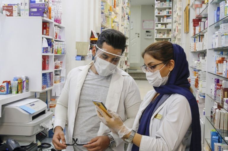 An Iranian doctor (R) and a pharmacist talk at a drugstore in downtown Tehran, Iran, 20 July 2020. Media reported that Iran has been blaming US over the sanctions which even has been followed over the
