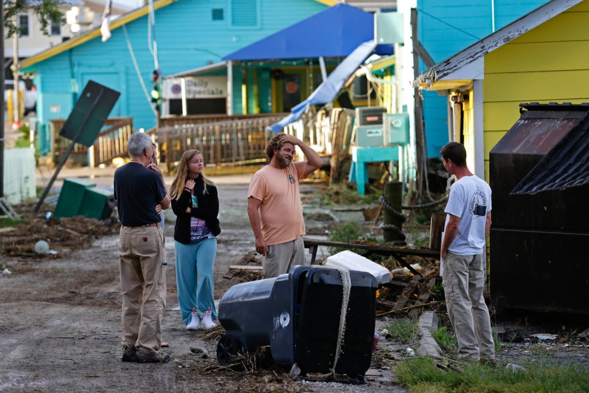 Residents survey the damages along the waterfront following the effects of Hurricane Isaias in Southport, N.C., Tuesday, Aug. 4, 2020. (AP Photo/Gerry Broome)
