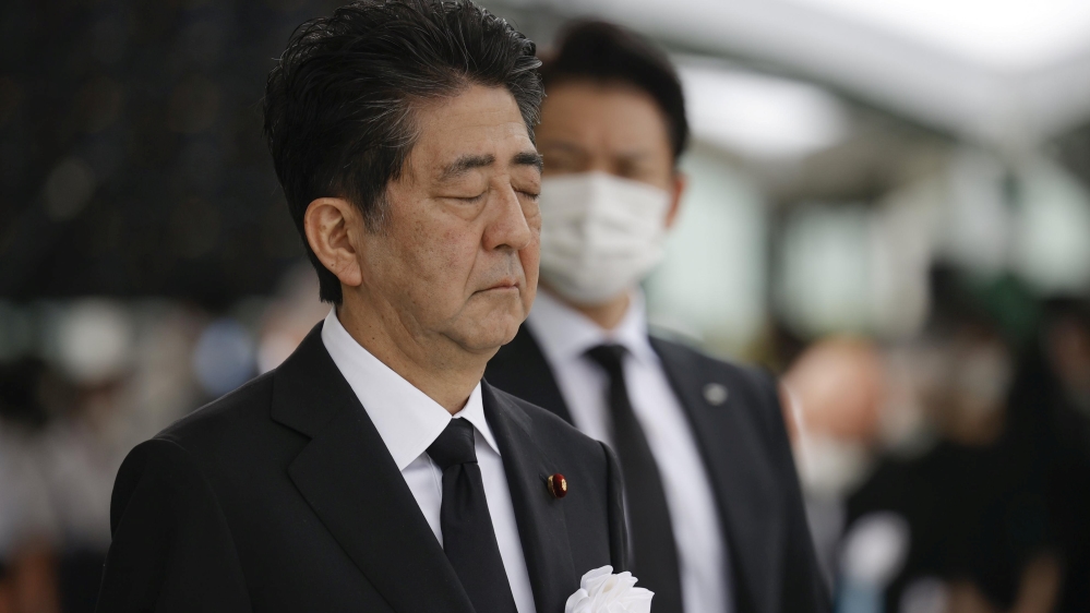 Japan's Prime Minister Shinzo Abe offers a silent prayer for the victims of the 1945 atomic bombing, at Peace Memorial Park in Hiroshima, Japan