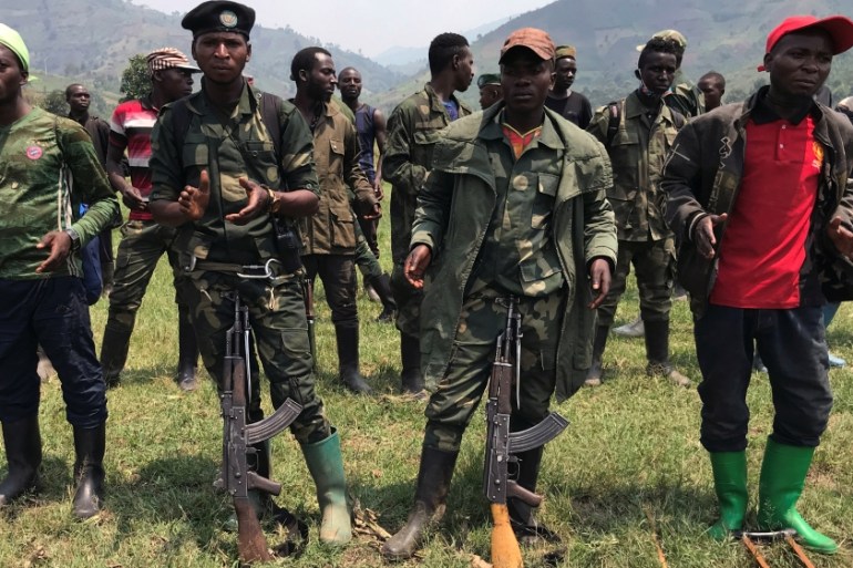 Members of the NDC-R rebel group parade as they surrender to the government forces in Kashuga, North Kivu province
