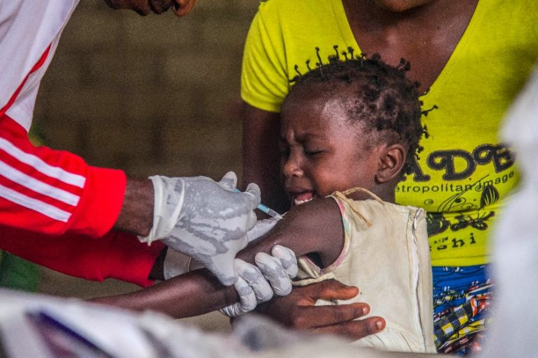 A toddler undergoes a measles vaccination at a centre in Temba, near Seke Banza, western DR Congo on March 3, 2020. Seventy-three thousand children from 6 months to 15 years old