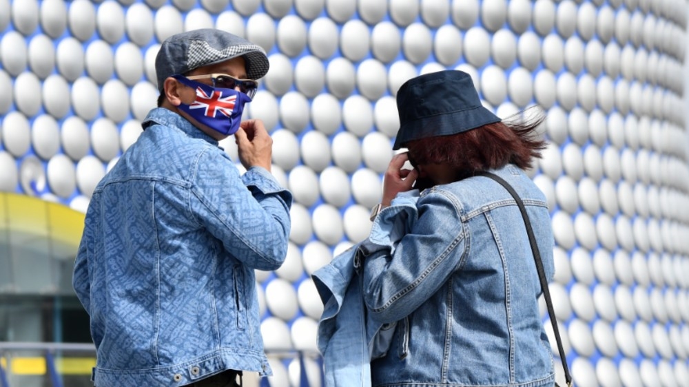 People wearing protective face masks are seen outside the Bullring shopping centre in Birmingham, central England on August 22, 2020, as Britain's second-city, home to more than one million people,