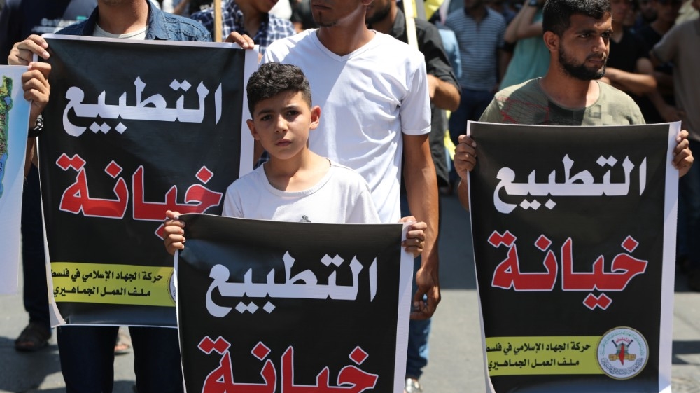 Palestinians hold banners reading 