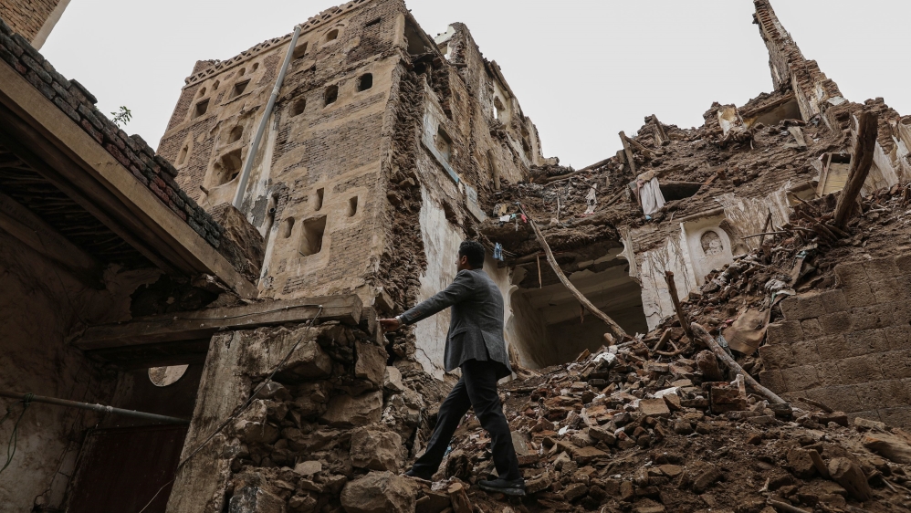 A man walks past a building collapsed by rain in the UNESCO World Heritage site of the old city of Sanaa