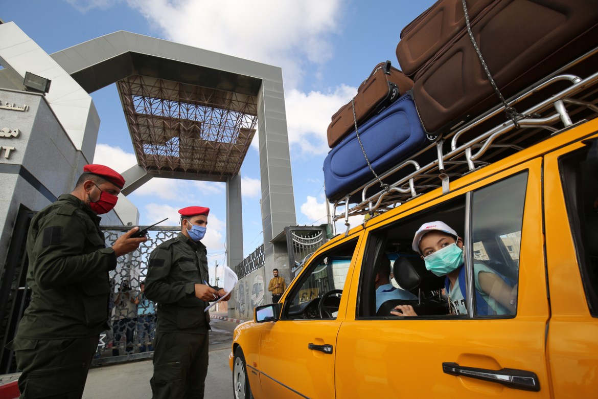 Palestinians prepare to leave Rafah border crossing with Egypt after months of closure due to the coronavirus pandemic in the southern Gaza Strip, on August 11, 2020 . (Photo by SAID KHATIB / AFP)