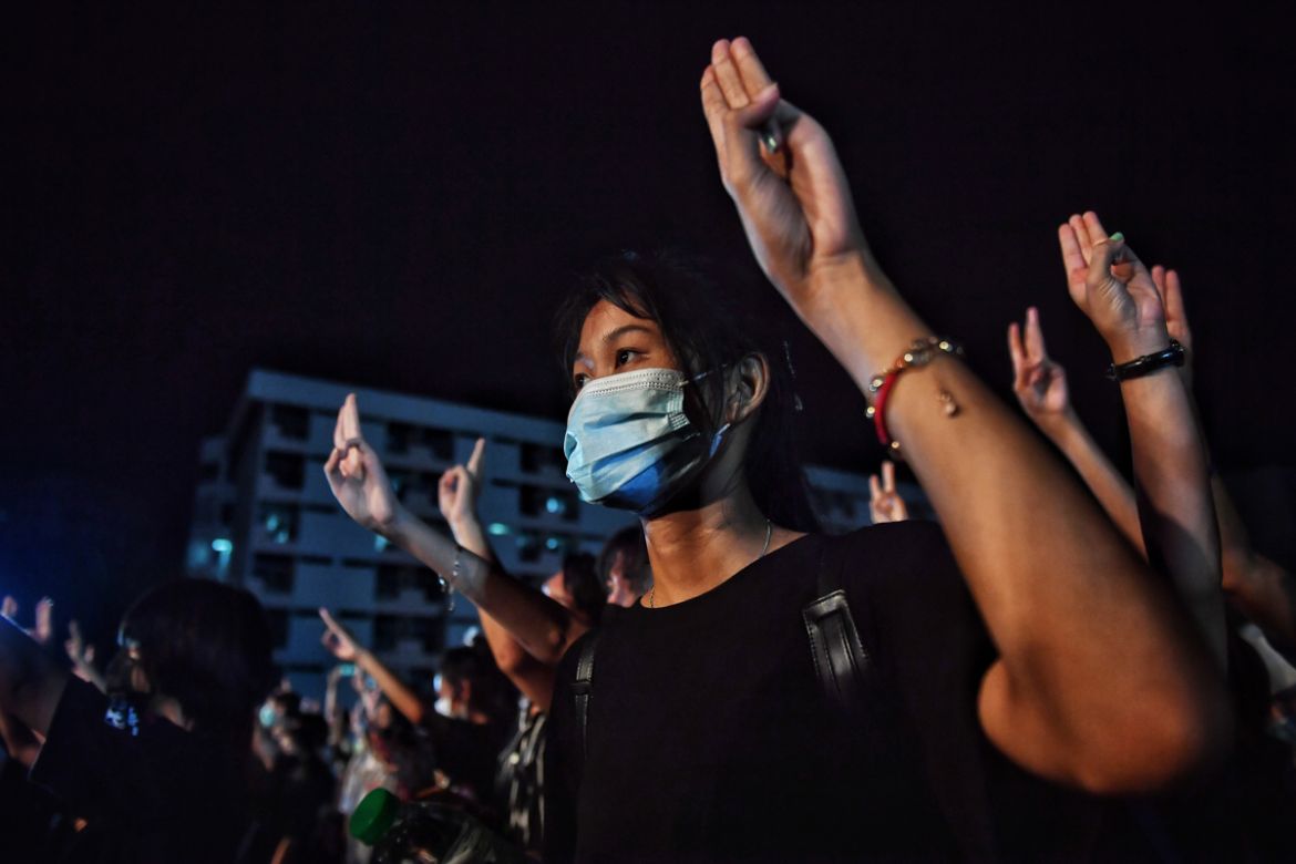 Student protesters flash the three-fingered Hunger Games salute during an anti-government rally at Mahidol University in Nakhon Pathom on August 18, 2020. - The country has seen near-daily protests in