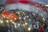 Belarusian opposition supporters light phones  and wave  flags during a protest rally at Independent Square in Minsk, Belarus on August 19, 2020 [AP Photo/Dmitri Lovetsky]