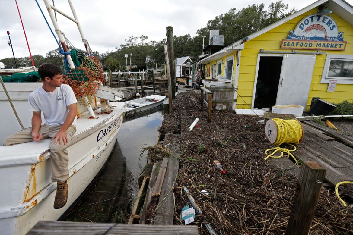 Royce Potter, a fifth generation seafood fisherman, surveys the damage to his business, Potter''s Seafood Market, following the effects of Hurricane Isaias in Southport, N.C., Tuesday, Aug. 4, 2020. Po
