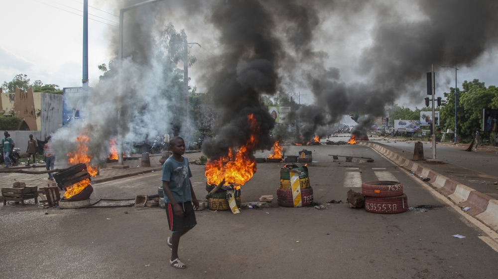 Anti-government protesters burn tires and barricade roads in the capital Bamako, Mali, Friday, July 10, 2020. Thousands marched Friday in Mali's capital in anti-government demonstrations urged by an o