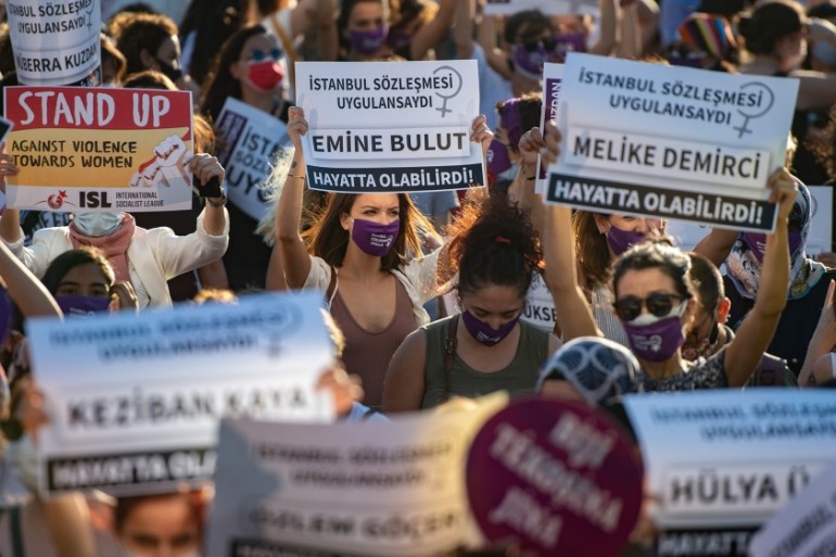 Demonstrators wearing protective face masks hold up placards during a demonstration for a better implementation of the Istanbul Convention and the Turkish Law 6284 for the protection of the family and