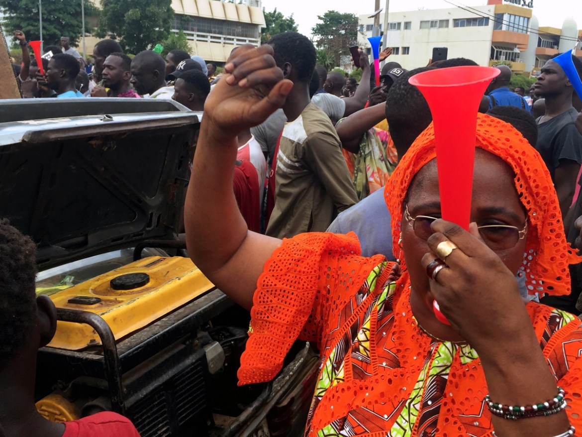 An opposition supporter reacts to the news of a possible mutiny of soldiers in the military base in Kati, outside the capital Bamako, at Independence Square in Bamako, Mali August 18, 2020. REUTERS/Re
