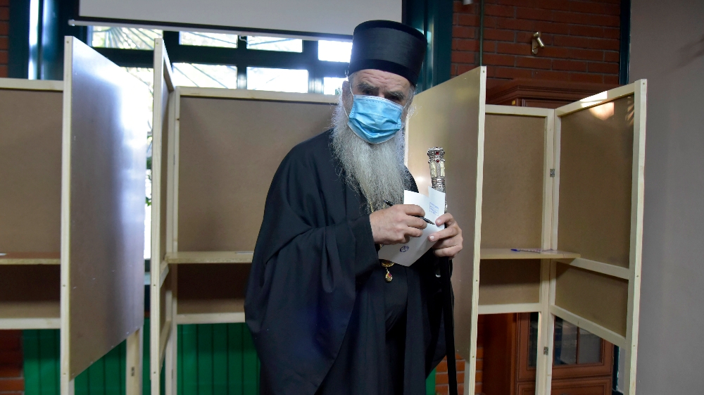 Serbian Orthodox bishop Amfilohije wearing a mask against the spread of the coronavirus prepares to vote in parliamentary elections at a polling station in Cetinje, south of Podgorica, Montenegro,