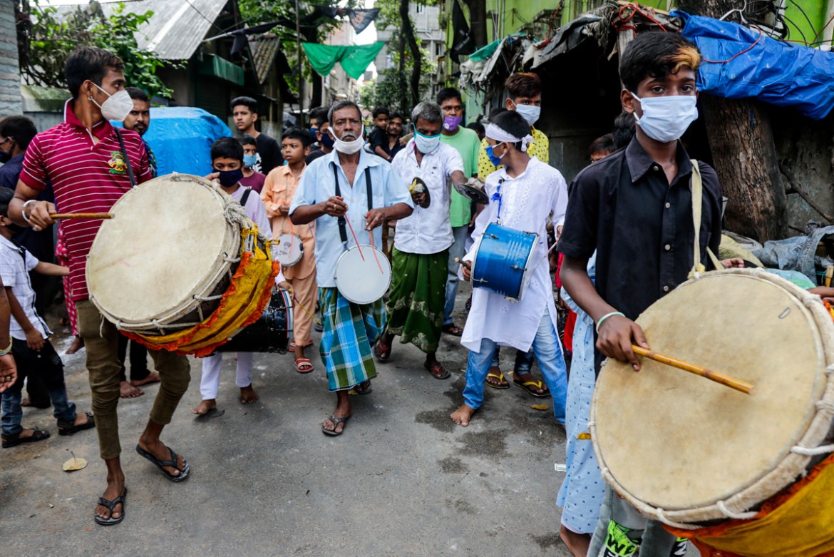 Muslims wearing face mask to prevent coronavirus beat drums as they take part of Muharram procession in Kolkata, India, Sunday, Aug. 30, 2020. India has the third-highest coronavirus caseload after th