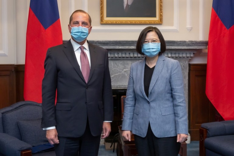 U.S. Secretary of Health and Human Services Alex Azar and Taiwan President Tsai Ing-wen, both wearing face masks, pose for photos during their meeting at the presidential office, in Taipei