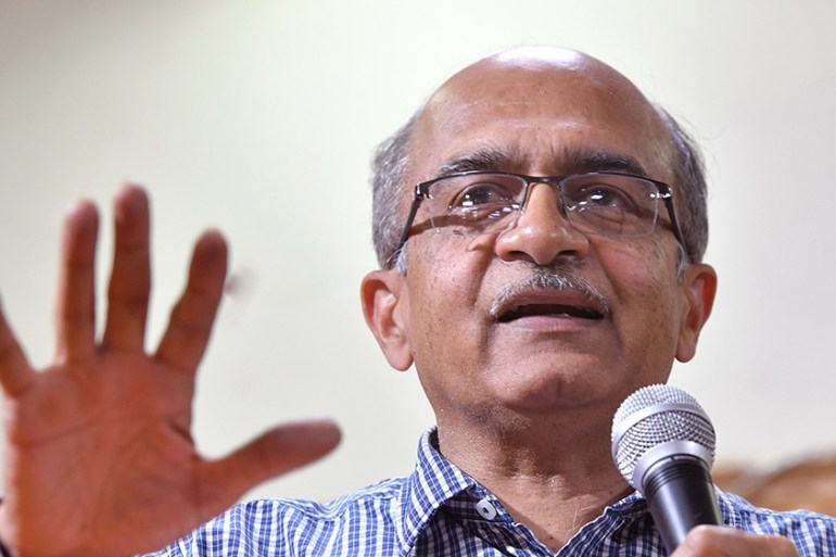 Indian Supreme Court lawyer and anti-corruption activist Prashant Bhushan (L) gestures as he speaks during a public talk, in Bangalore on March 30, 2019. (Photo by MANJUNATH KIRAN / AFP)