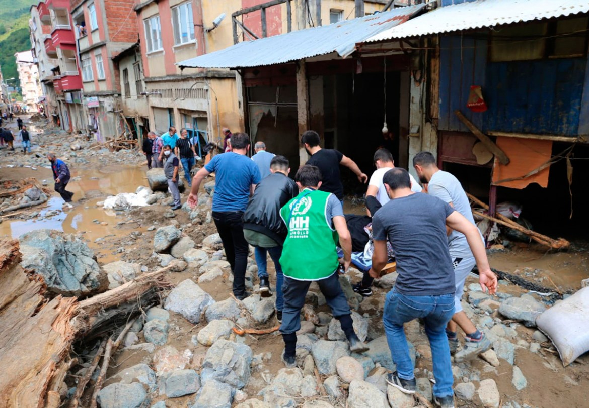 People carry a rescued person from the scene after floods caused by heavy rain in the mountain town of Dereli in Giresun province, along Turkey''s Black Sea coastline, Sunday, Aug. 23, 2020. The interi