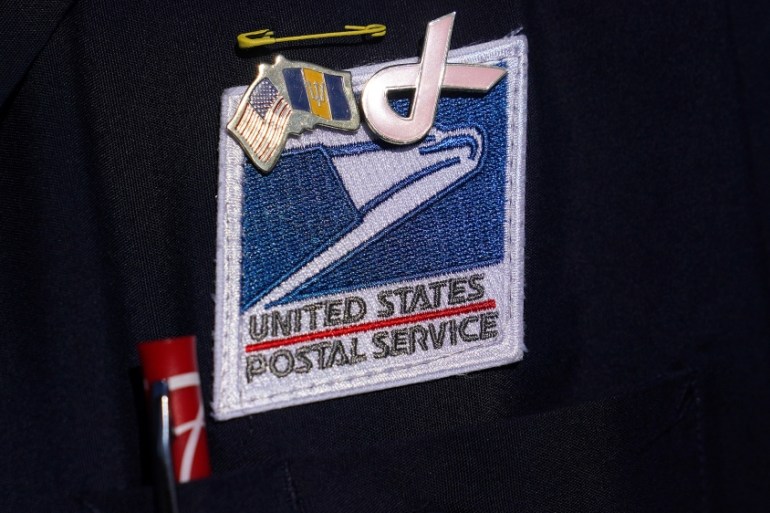 A U.S Postal Service badge is pictured during a news conference about the postal service in the Manhattan borough of New York City, New York, U.S., August 18, 2020. REUTERS/Carlo Allegri