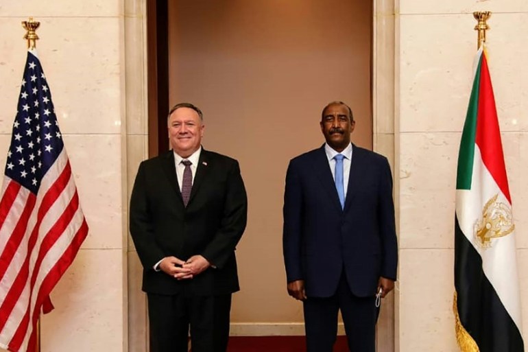 A handout picture provided by Sudan''s Foreign Media Council shows US Secretary of State Mike Pompeo (L) posing for a picture with Sudan''s Sovereign Council chief General Abdel Fattah al-Burhan in Khar