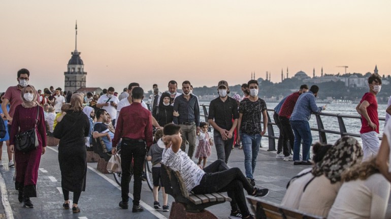 People enjoy themselves near the Bosphorus on sunset in Istanbul, Turkey, 23 August 2020. Turkish authorities have now allowed the reopening of restaurants, cafes, parks and beaches, as well as liftin