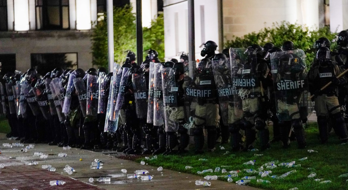 epa08623650 Law enforcement officers wear riot gear as they face angry crowds during a second night of unrest in the wake of the shooting of Jacob Blake by police officers, in Kenosha, Wisconsin, USA,