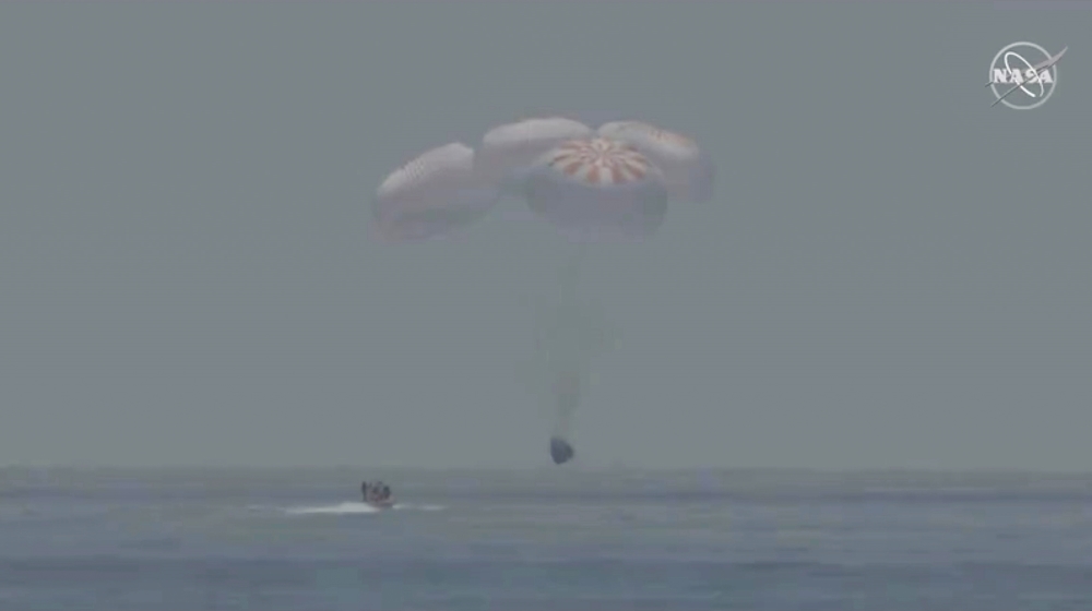 A capsule with NASA astronauts Robert Behnken and Douglas Hurley splashes down in the Gulf of Mexico, August 2, 2020, in this screen grab taken from a video. NASA/Handout via REUTERS