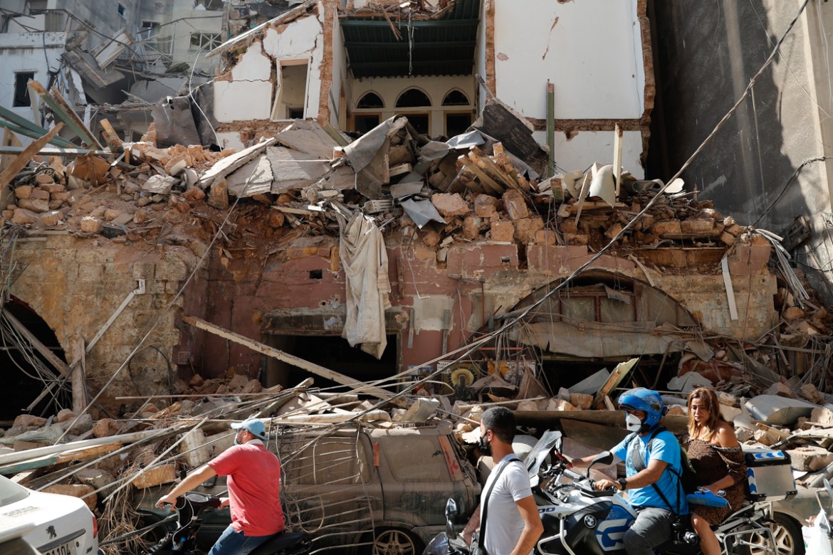 Citizens ride their scooters and motorcycles pass in front of a house that was destroyed in Tuesday''s massive explosion in the seaport of Beirut, Lebanon, Wednesday, Aug. 5, 2020. Residents of Beirut
